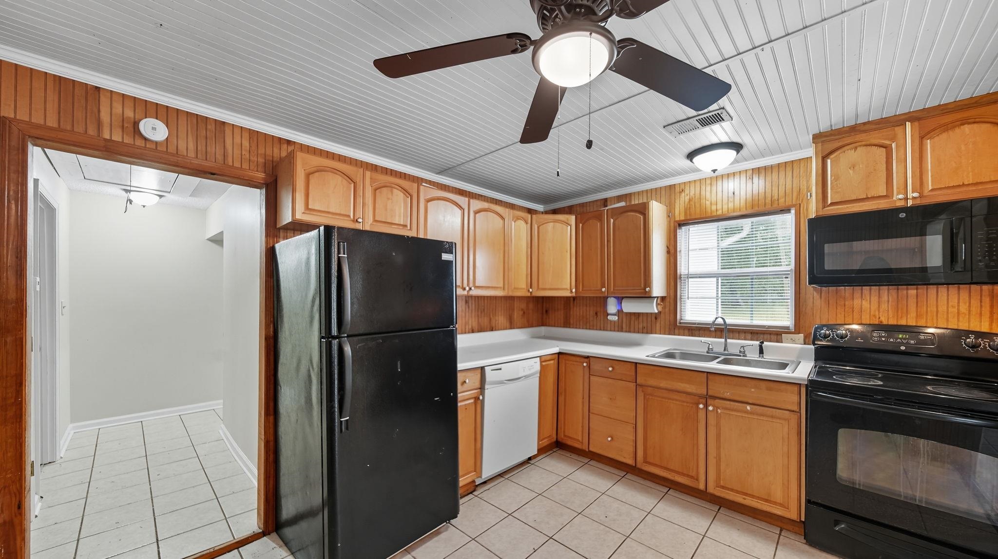 1503 Beaver Road Munford, TN 38058 - Photo 9 of 29 a kitchen with a refrigerator a sink and cabinets