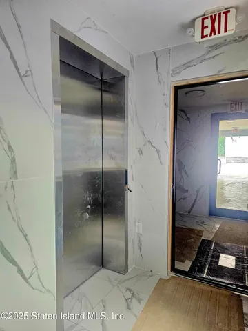 a bathroom with a shower and a sink