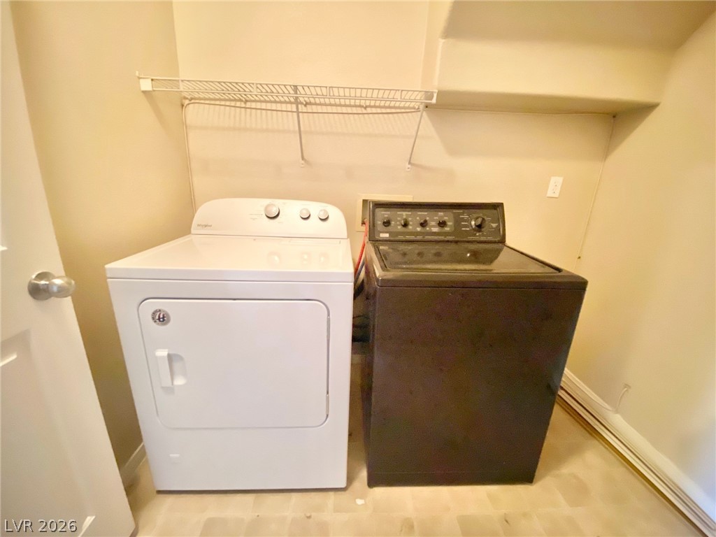 8569 Rhamus Court Las Vegas, NV 89149 - Photo 7 of 35 Functional laundry space includes a washer and dryer, complemented by a convenient overhead shelf.