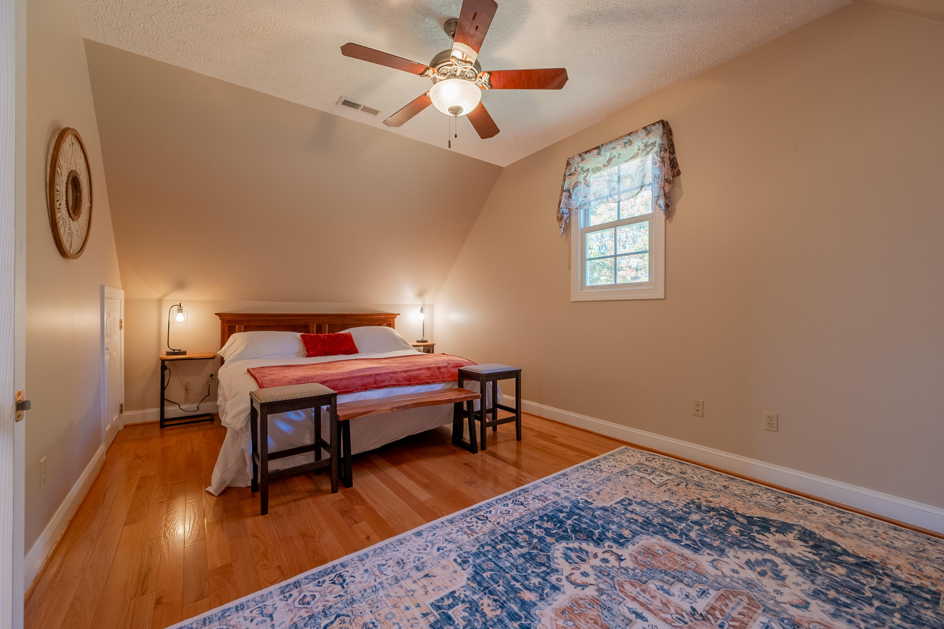 254 Dusty Mile Road Northwest Willis, VA 24380 - Photo 104 of 122 a bedroom with furniture and a wooden floor