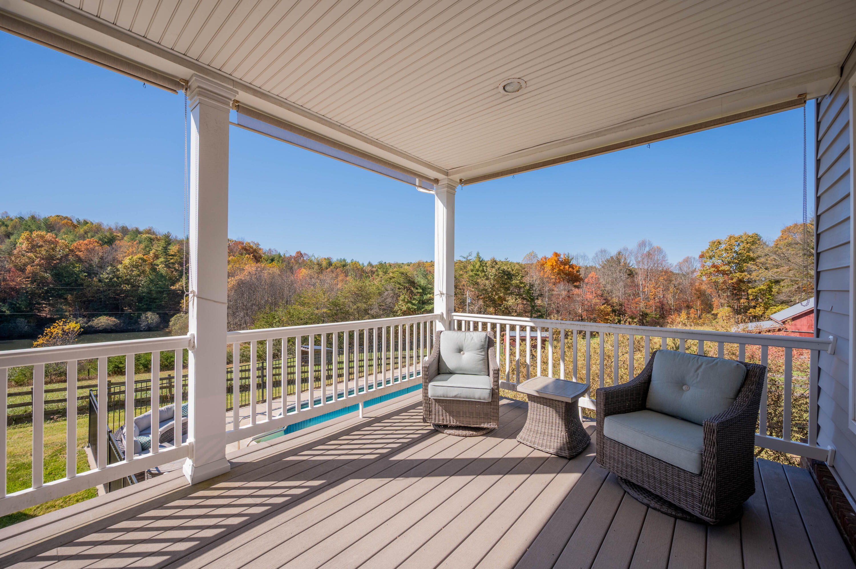 254 Dusty Mile Road Northwest Willis, VA 24380 - Photo 15 of 122 a balcony with wooden floor table and chairs