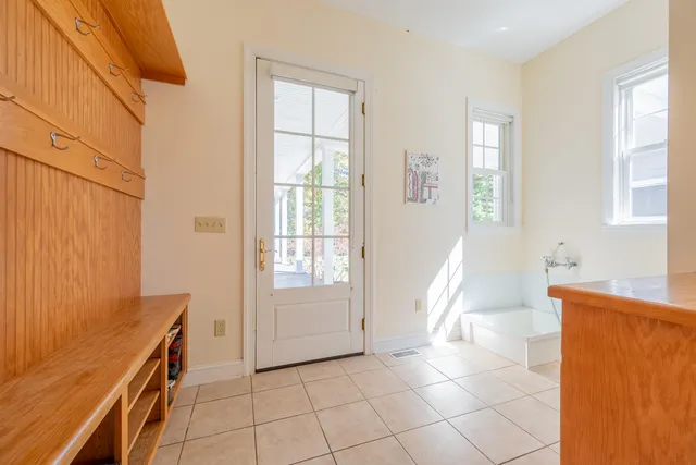 a bath tub sitting in a bathroom next to a window