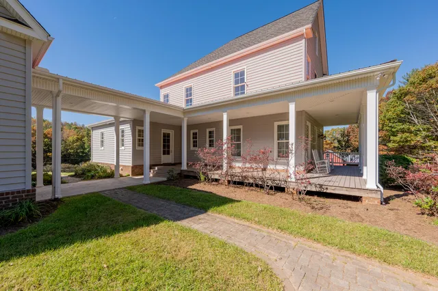a view of a house with backyard sitting area and garden