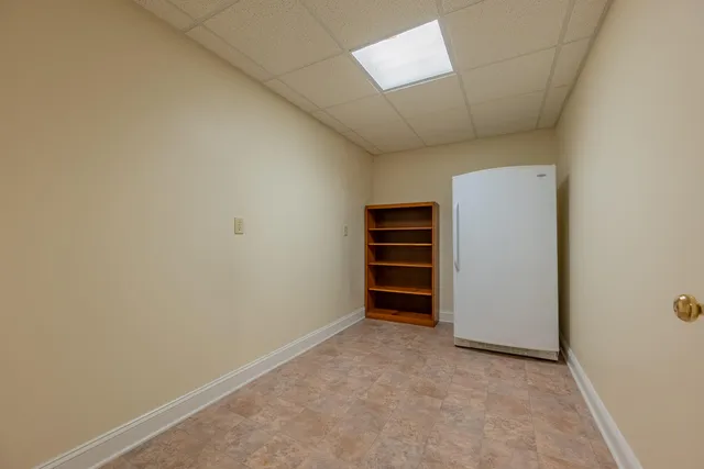 a kitchen with stainless steel appliances granite countertop a refrigerator a sink dishwasher and wooden cabinets with wooden floor