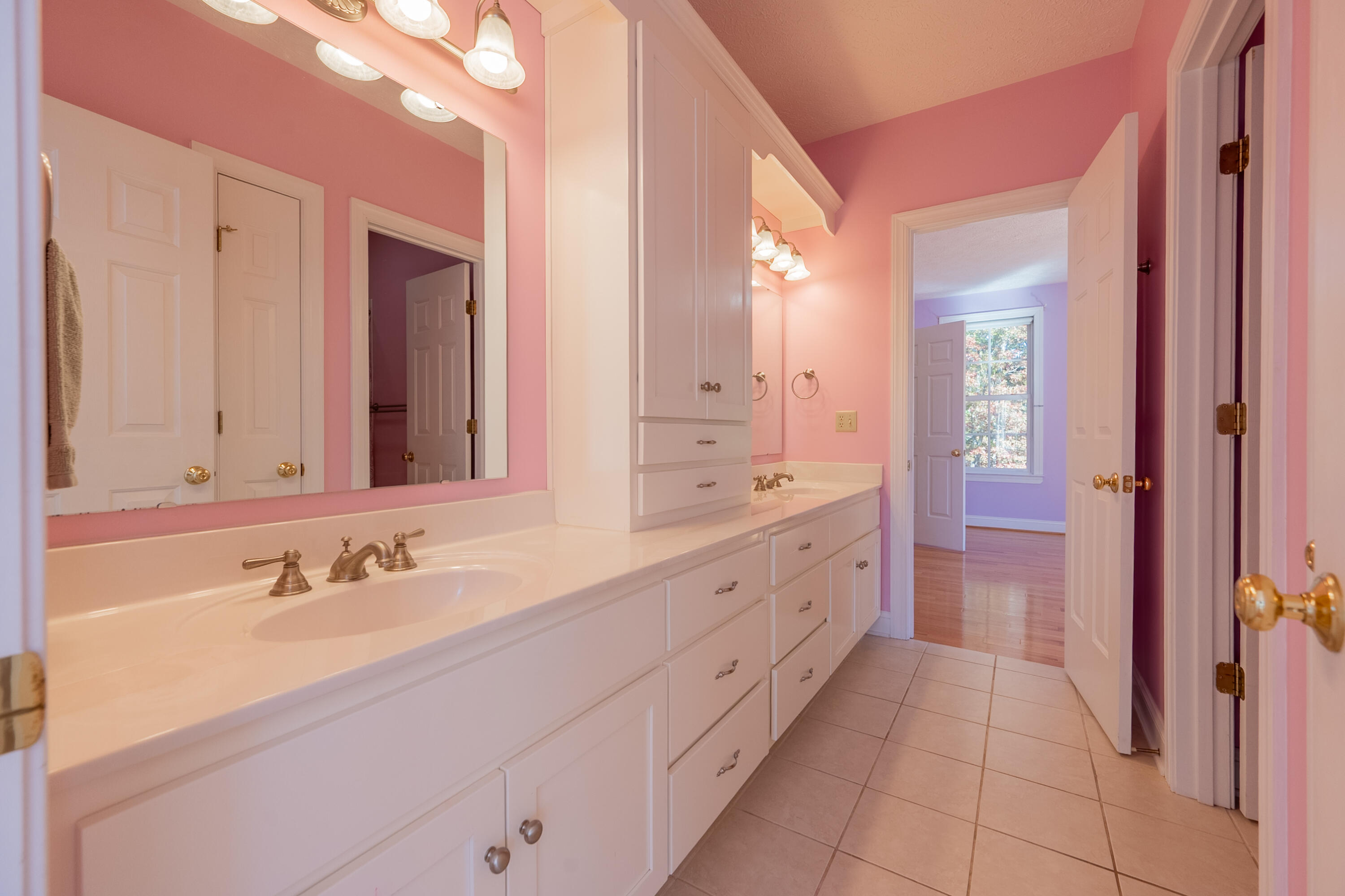 254 Dusty Mile Road Northwest Willis, VA 24380 - Photo 72 of 122 a spacious bathroom with a double vanity sink a mirror and a bathtub