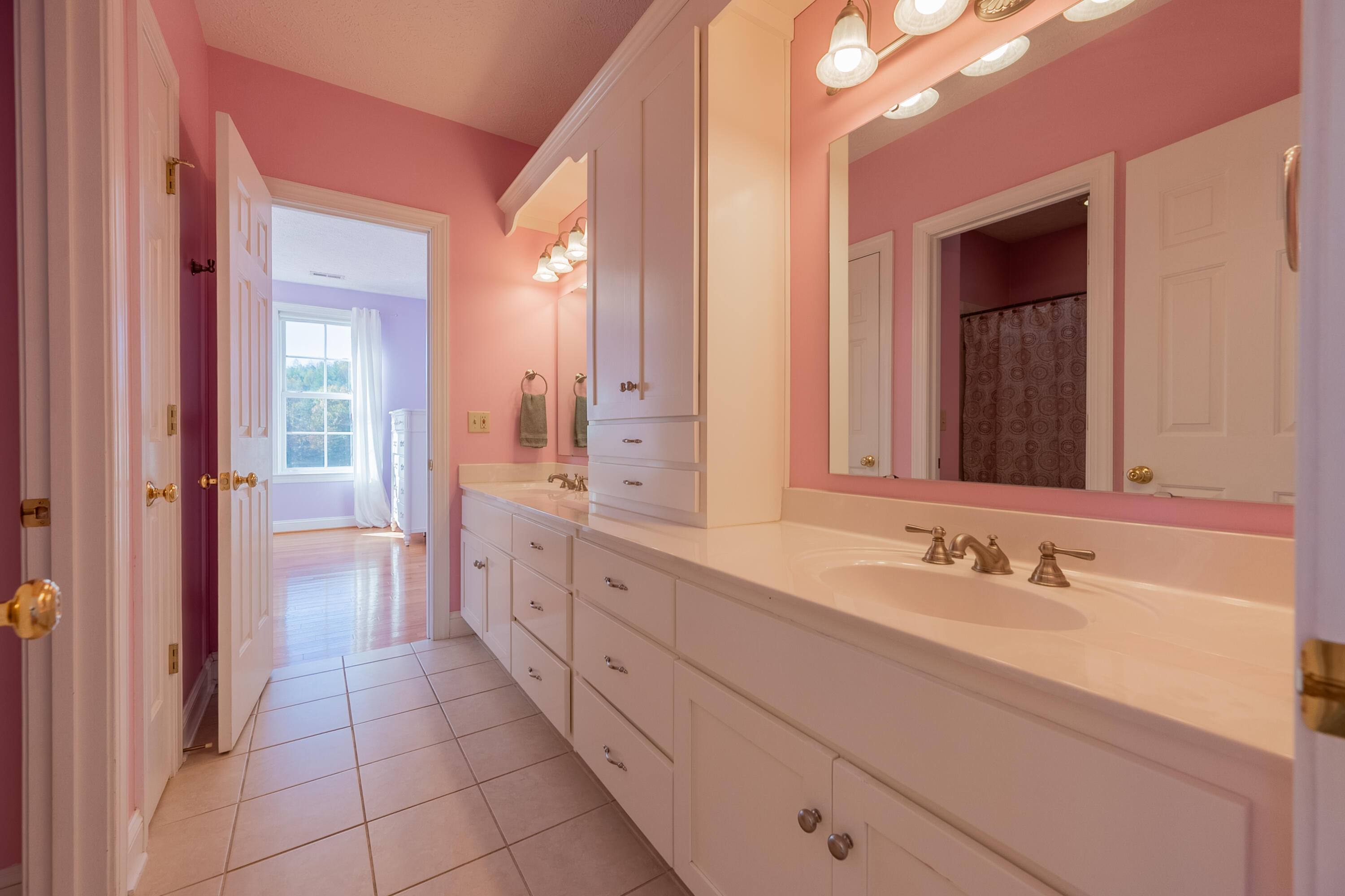 254 Dusty Mile Road Northwest Willis, VA 24380 - Photo 74 of 122 a spacious bathroom with a double vanity sink a mirror and a bathtub
