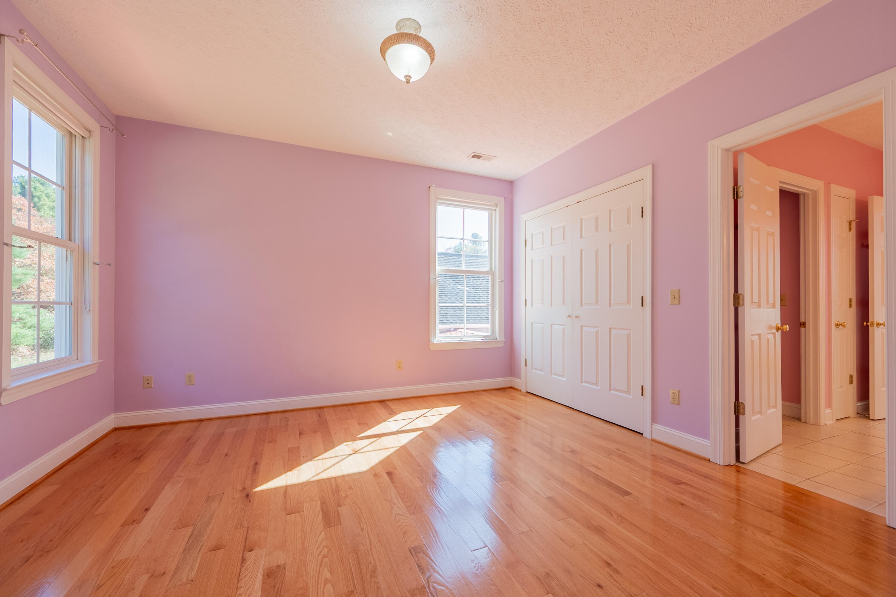 254 Dusty Mile Road Northwest Willis, VA 24380 - Photo 77 of 122 an empty room with wooden floor and windows