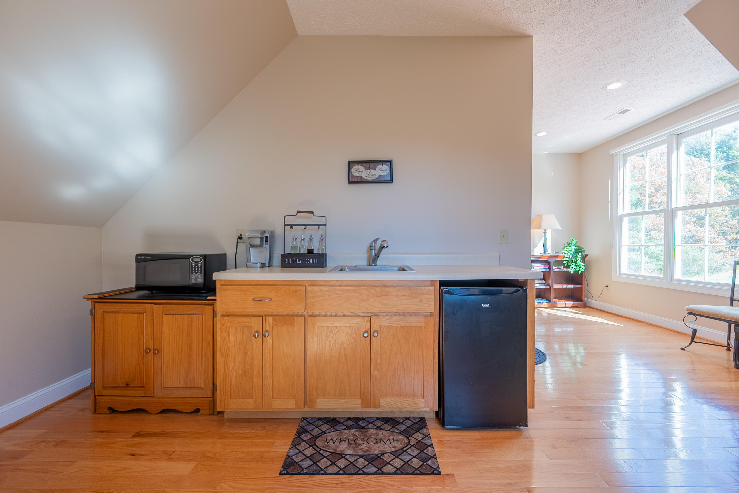 254 Dusty Mile Road Northwest Willis, VA 24380 - Photo 100 of 122 a kitchen with stainless steel appliances granite countertop a refrigerator a sink dishwasher and wooden cabinets with wooden floor