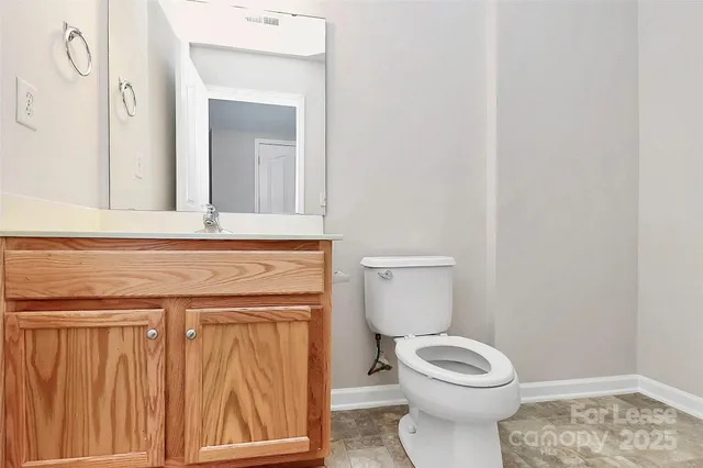 a bathroom with a toilet a sink and a window