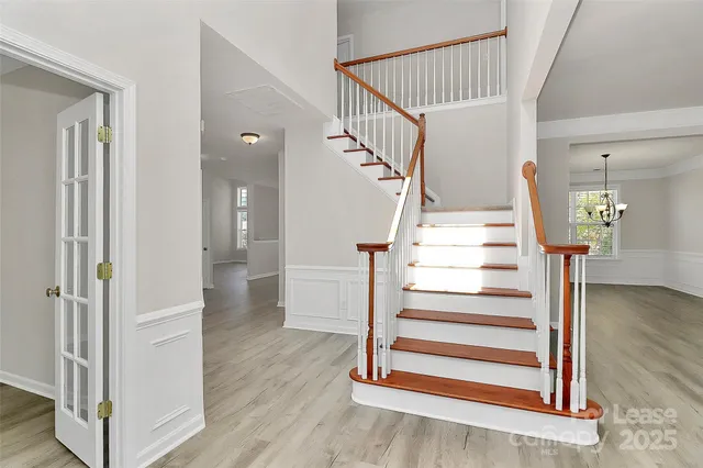 a view of entryway and hall with wooden floor