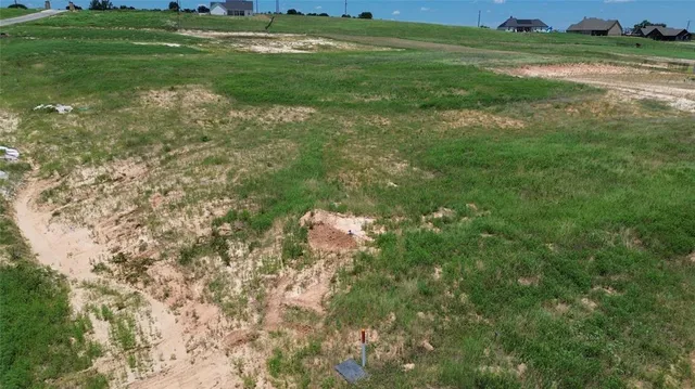 a backyard of a house with lots of green space and mountain view in back