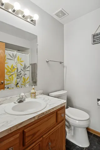 a bathroom with a sink toilet and mirror
