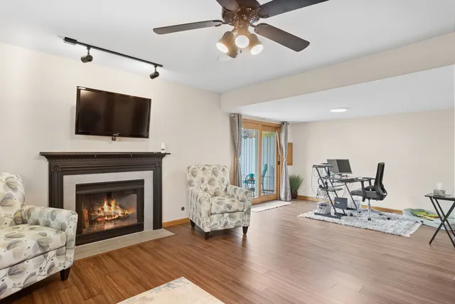 a living room with furniture a fireplace and a flat screen tv