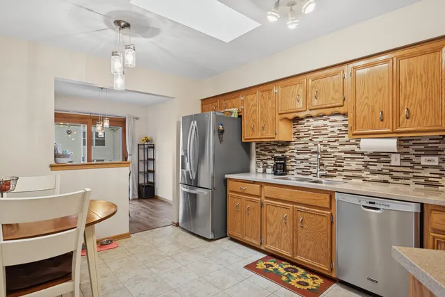 a kitchen with refrigerator cabinets and a sink