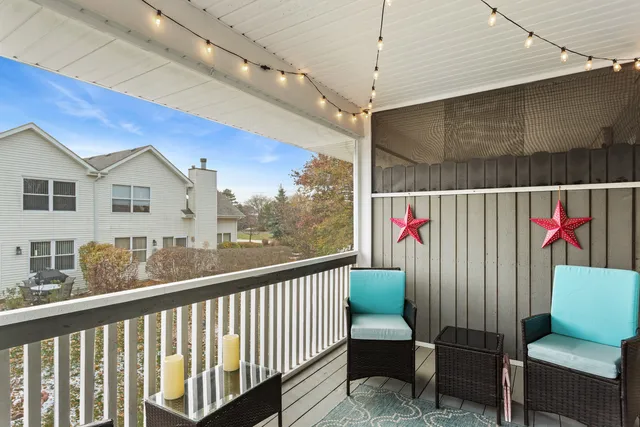 a view of a chairs and table in the balcony