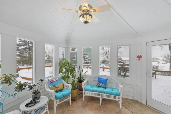 a room with pool table and a wooden floor