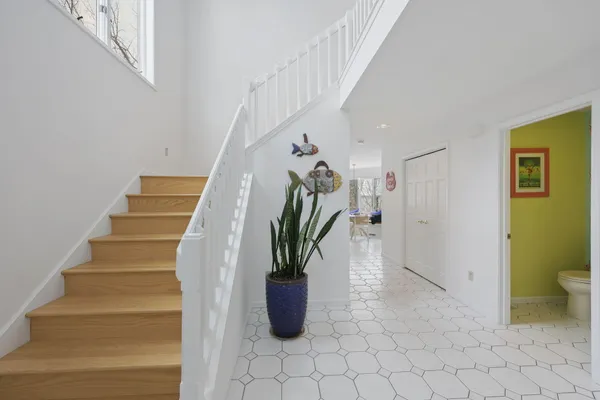 a living room with fireplace furniture and a potted plant