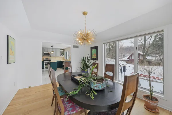 a living room with furniture flowerpot and wooden floor