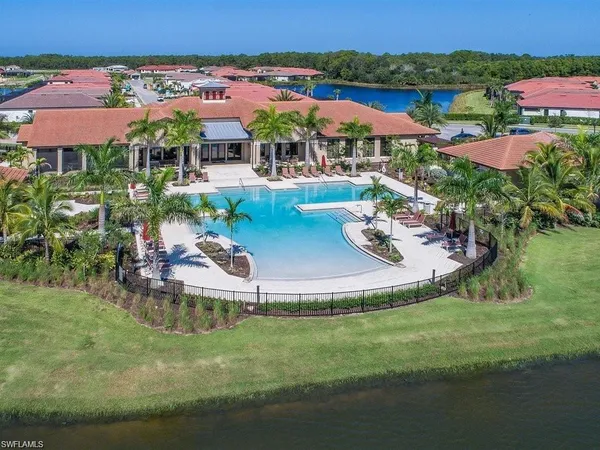 an aerial view of a house with garden space and lake view
