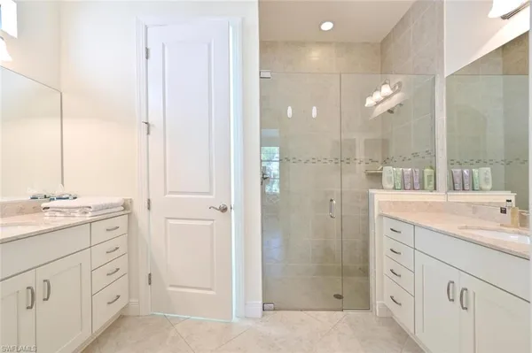 a spacious bathroom with a shower sink and mirror