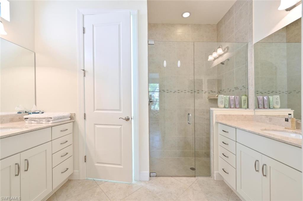 1326 Kendari Terrace Naples, FL 34113 - Photo 14 of 37 a spacious bathroom with a shower sink and mirror