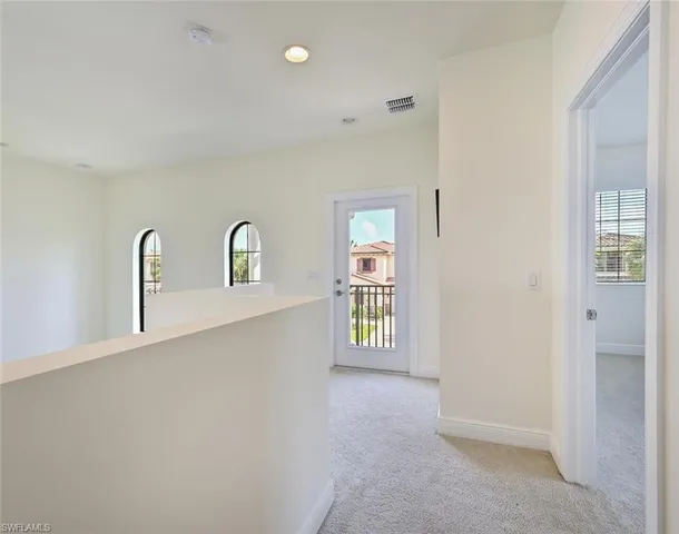 a bedroom with a bed and dresser with mirror