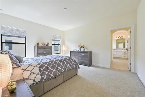 a spacious bathroom with a double vanity sink mirror and bathtub
