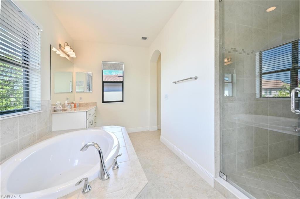 1326 Kendari Terrace Naples, FL 34113 - Photo 18 of 37 a spacious bathroom with a tub sink and mirror