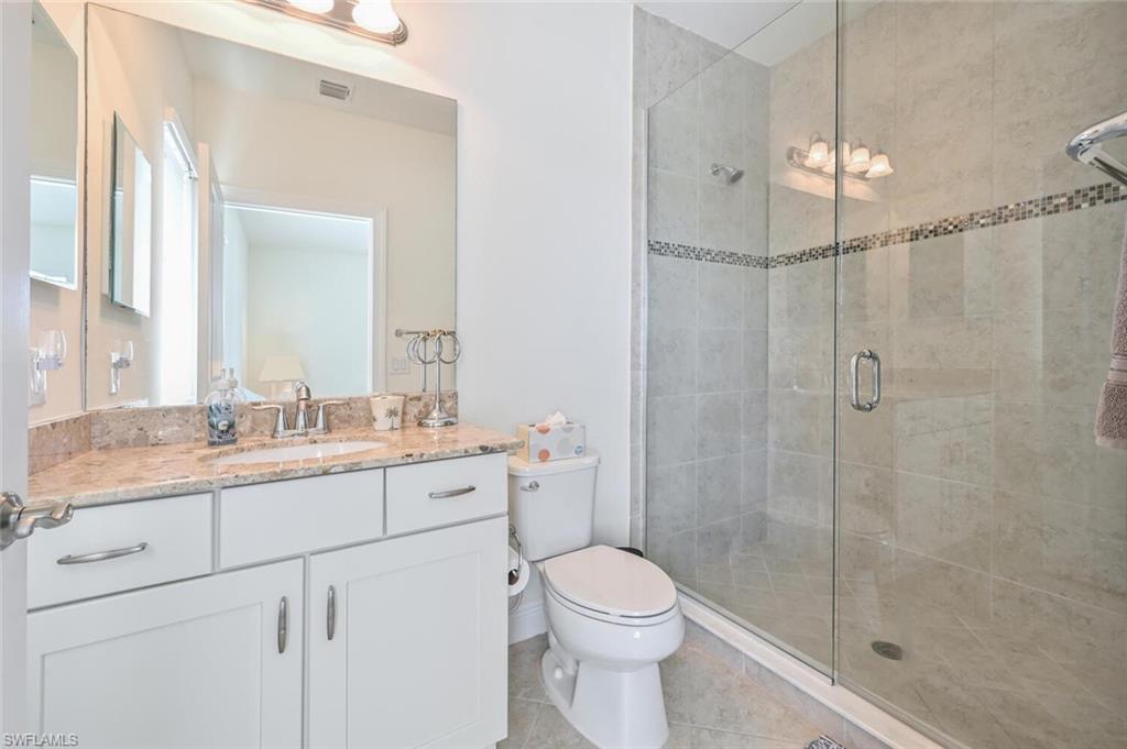 1326 Kendari Terrace Naples, FL 34113 - Photo 20 of 37 a bathroom with a granite countertop sink a toilet and shower