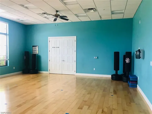 a room with pool table and windows