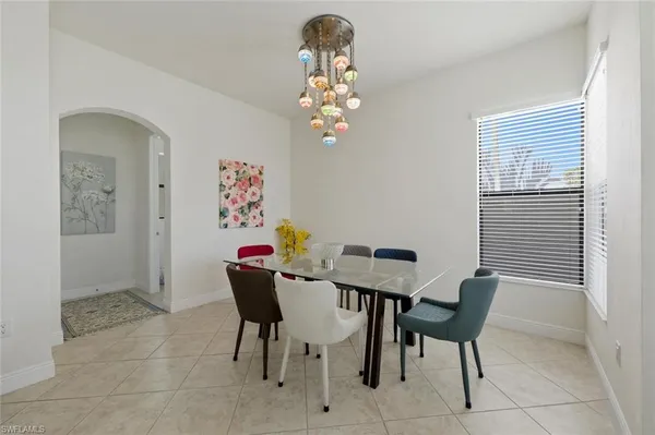 a view of a dining room with furniture and chandelier