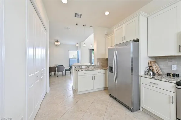 a kitchen with refrigerator and cabinets