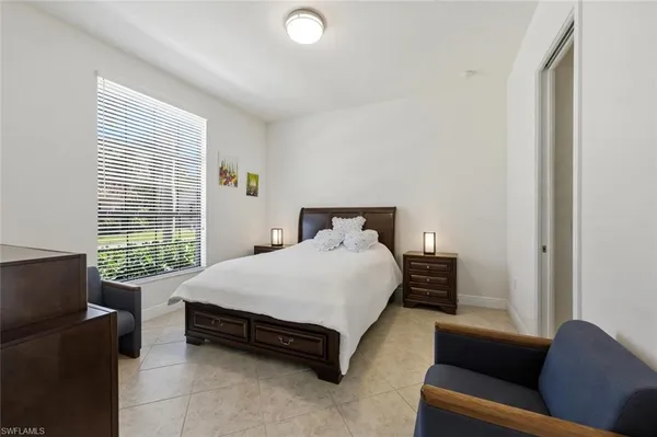 a bedroom with a bed couch and window