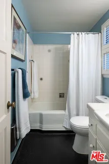 a bathroom with a sink a toilet and a shower