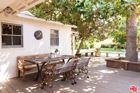 a view of backyard of house with seating space