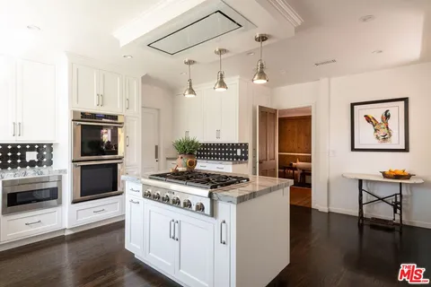 a kitchen with a stove and a refrigerator