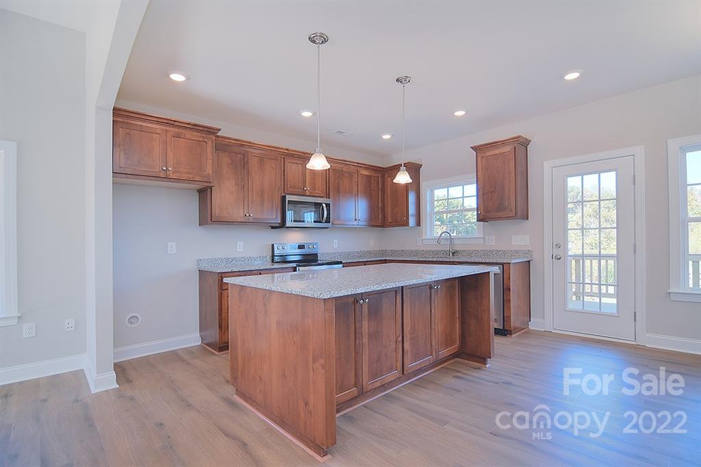0 Pepperidge Lane Monroe, NC 28110 - Photo 11 of 28 a large kitchen with stainless steel appliances granite countertop a sink a stove and a refrigerator