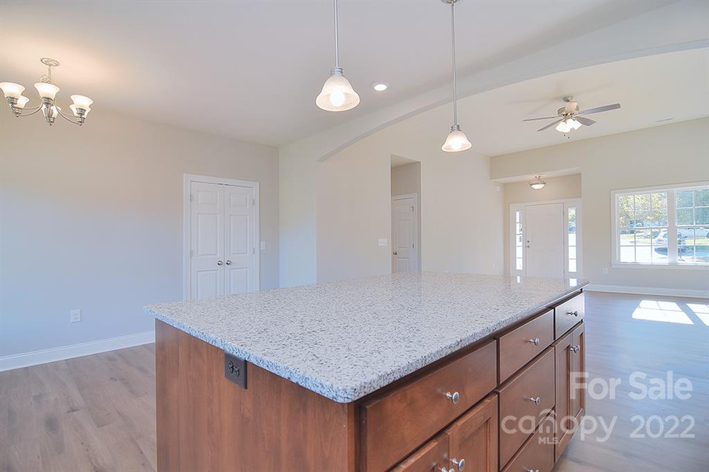 0 Pepperidge Lane Monroe, NC 28110 - Photo 14 of 28 a kitchen with kitchen island a counter top and chandelier