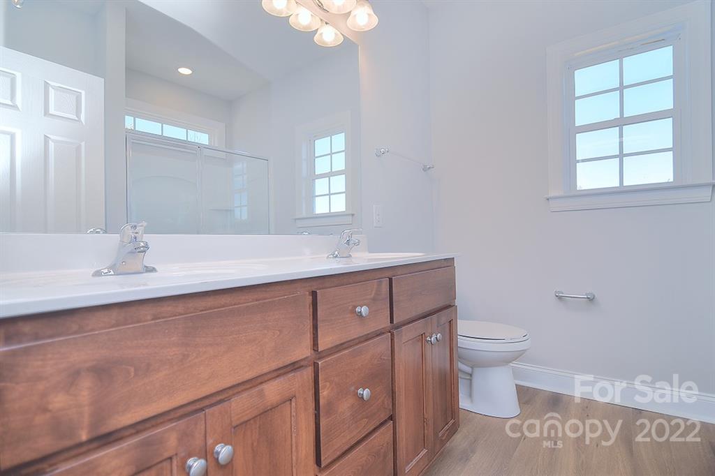 0 Pepperidge Lane Monroe, NC 28110 - Photo 24 of 28 a bathroom with a toilet sink and mirror