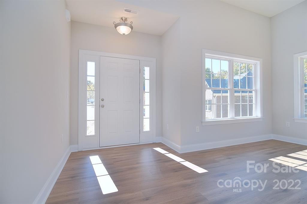 0 Pepperidge Lane Monroe, NC 28110 - Photo 4 of 28 an empty room with wooden floor and windows