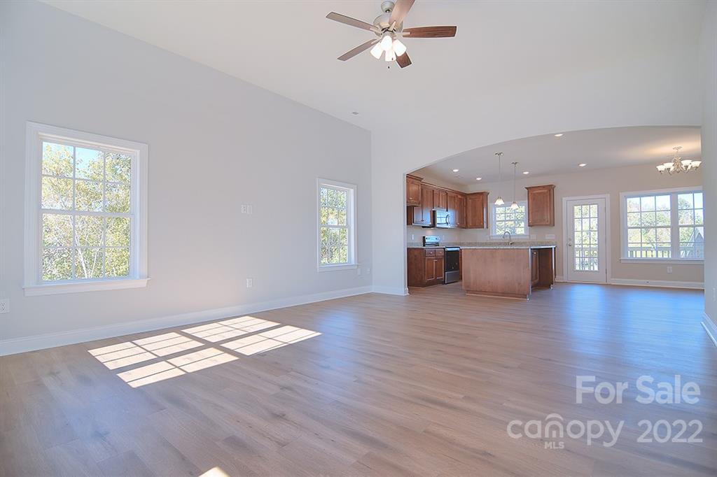 0 Pepperidge Lane Monroe, NC 28110 - Photo 5 of 28 a living room with a stove kitchen island a sink cabinets and wooden floor