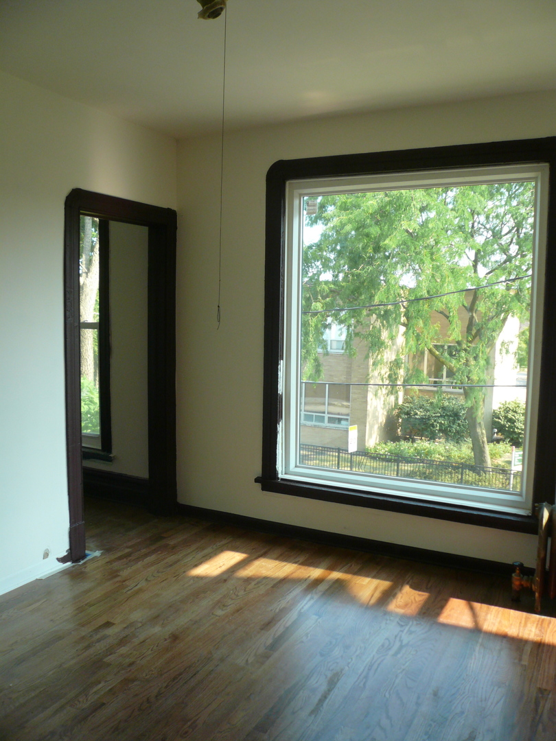 1132 East 44th Street Chicago, IL 60653 - Photo 16 of 23 a view of a room with wooden floor and window
