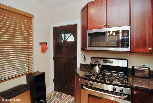 72 Pine Avenue, Unit 2B Riverside, IL 60546 - Photo 4 of 10 a kitchen with stainless steel appliances granite countertop a stove and a microwave