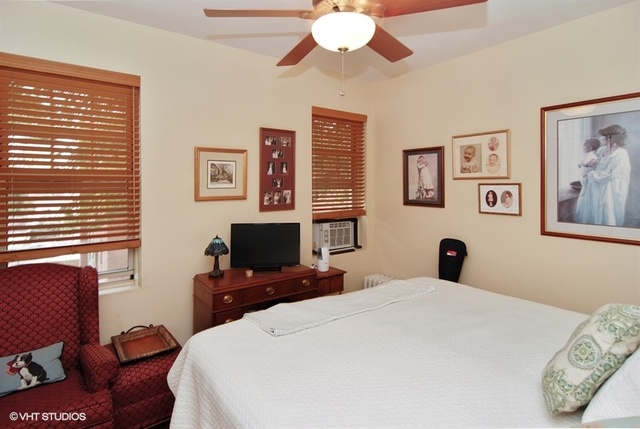 72 Pine Avenue, Unit 2B Riverside, IL 60546 - Photo 6 of 10 a bedroom with a bed and a flat screen tv