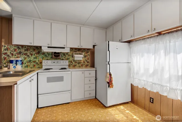 a kitchen with cabinets appliances and a counter space