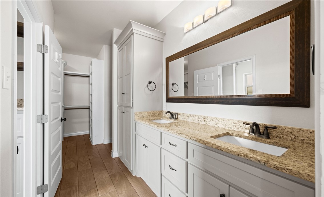 2517 Luzius Drive Corpus Christi, TX 78418 - Photo 14 of 25 a en suite bathroom with a granite countertop sink and a mirror