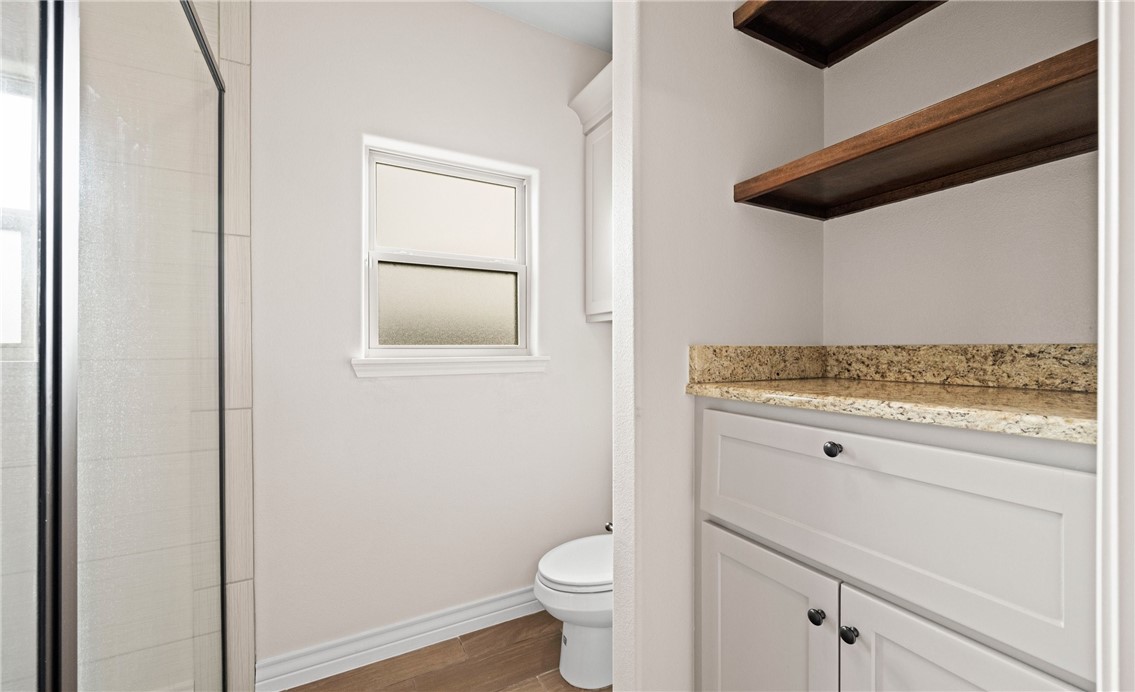 2517 Luzius Drive Corpus Christi, TX 78418 - Photo 15 of 25 a bathroom with a granite countertop toilet and a sink