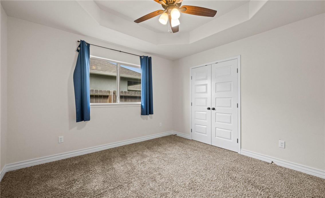 2517 Luzius Drive Corpus Christi, TX 78418 - Photo 18 of 25 an empty room with chandelier fan and windows