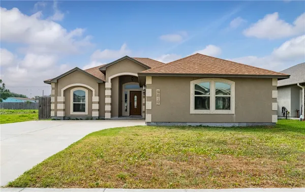a front view of a house with yard