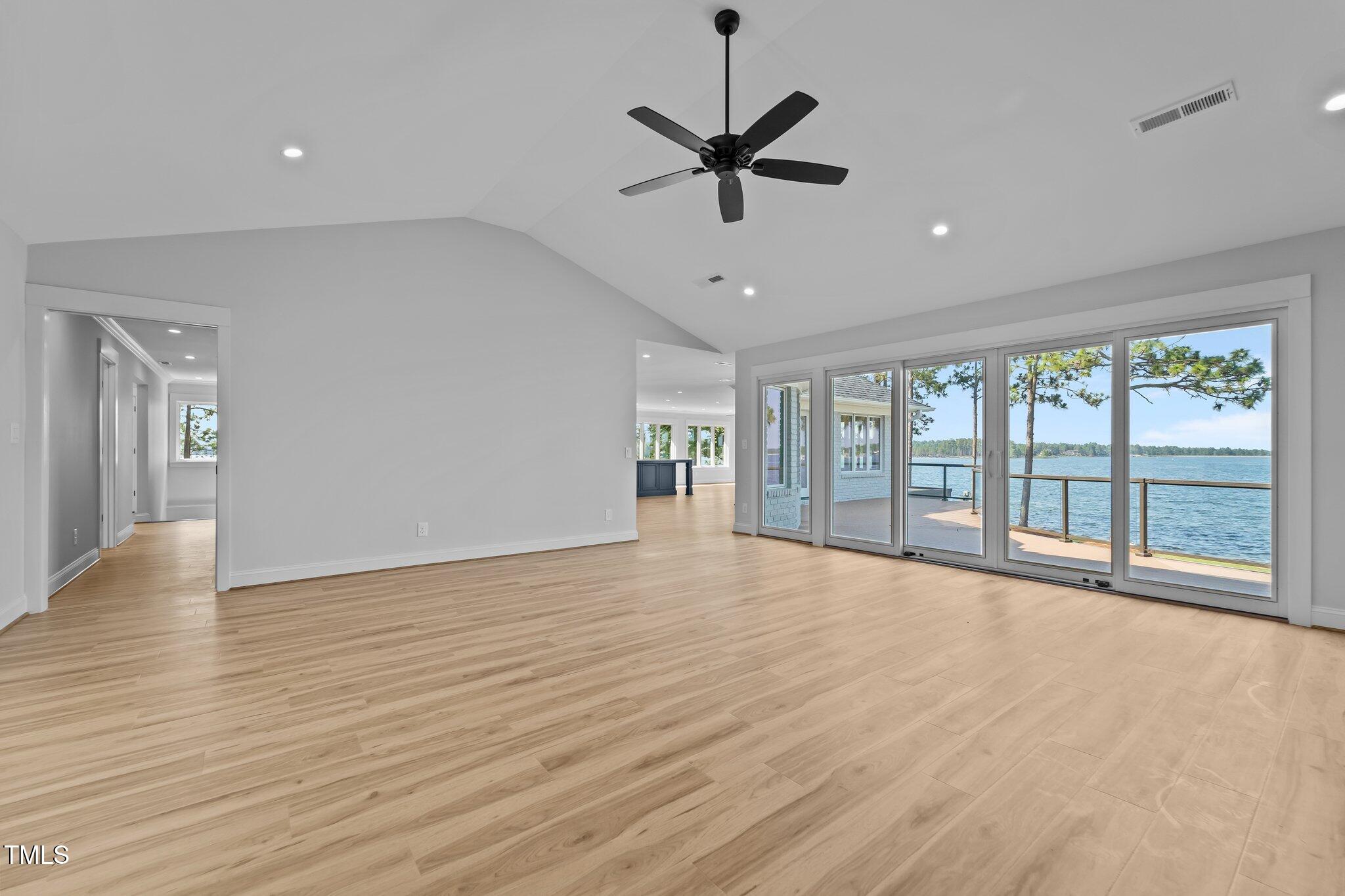 106 Mace Point West End, NC 27376 - Photo 10 of 79 a view of an empty room with a window and wooden floor